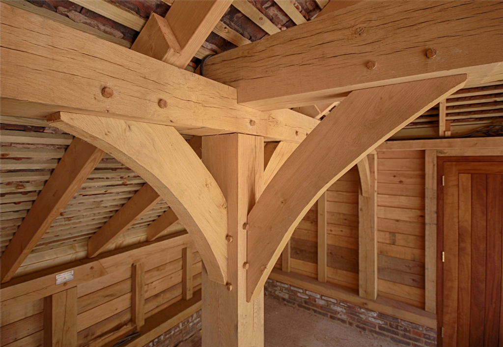 Curved oak frame braces in timber outbuilding Gallery Image