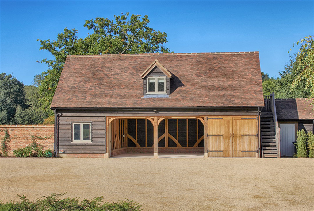 4 bay oak framed building with external staircase to access accomodation above. Gallery Image