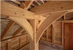 Curved oak frame braces in timber outbuilding Gallery Thumbnail