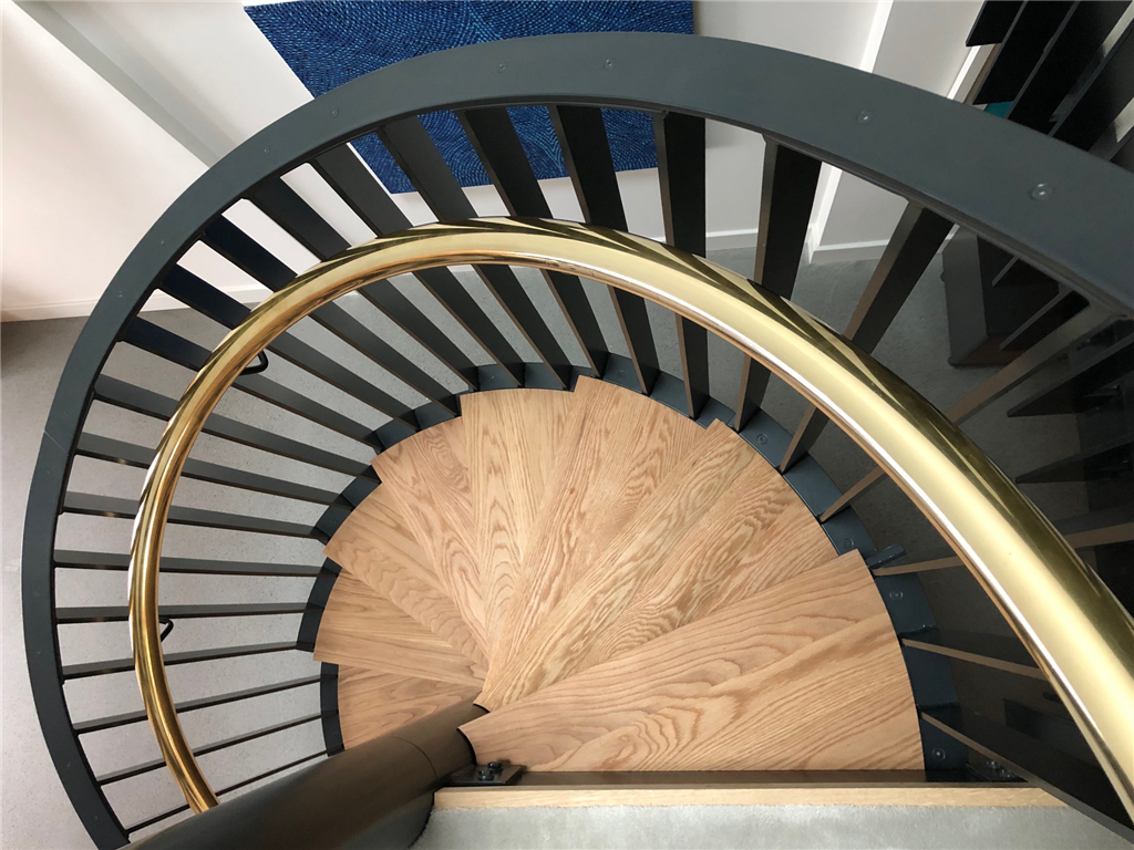 Stylish spiral staircase with brass handrail
 Gallery Image