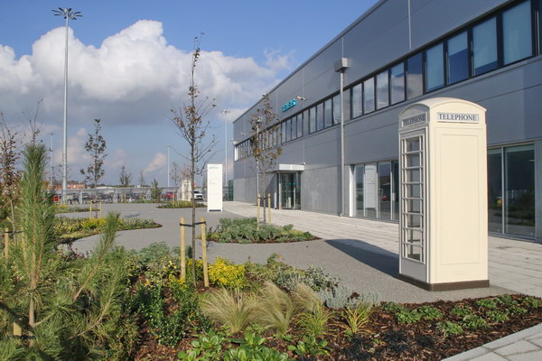 The design for Siemens' office main entrance at the new wind turbine factory in Hull incorporated Sustainable Drainage (SuDS). Permeable 'Flexipave' surfacing, with large areas of planting and trees. Gallery Image