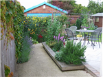 A domestic garden re-design. The previous conrete and lawn garden was transformed into a garden with seasonal interest, raised planters, smooth resin bound surface, a patio and a planted trellis. Gallery Thumbnail