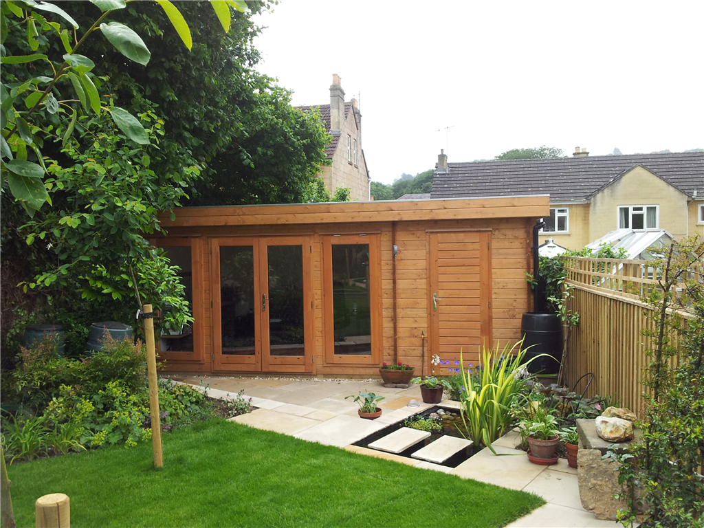 Garden Log Cabin with low profile flat roof & combined / integral store room / shed.  Makes the perfect garden office or studio room for hobbies. Gallery Image