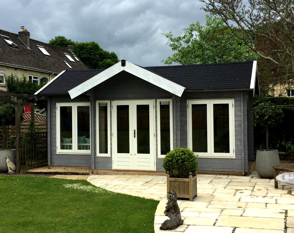 Beautiful garden log cabin with canopy.  Available in a range of sizes / styles.  Custom designs. Gallery Image