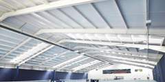 Internal view of Easton College Tennis Facility. Portal frame steelwork with Kingspan KS1000RW composite roof cladding. Gallery Image