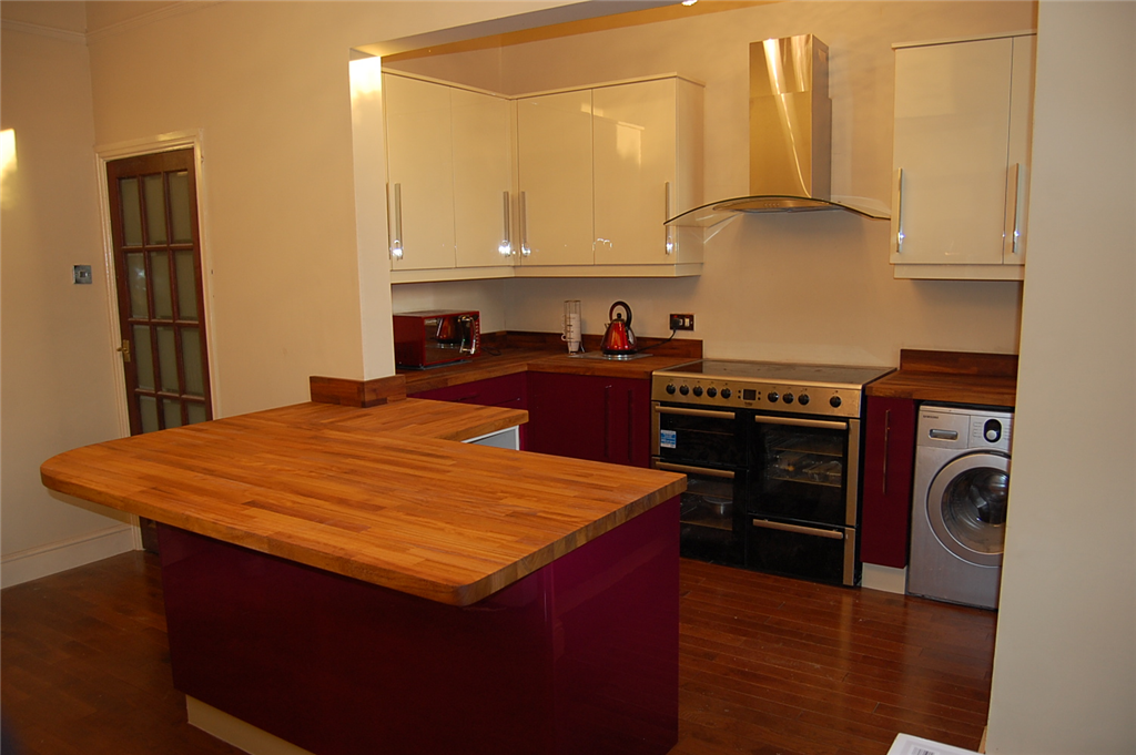 Claret & cream high gloss painted kitchen with oiled Iroko wood worktops. Gallery Image