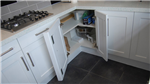 White painted shaker style kitchen with easy access corner cabinet. Gallery Thumbnail