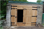 Solid Oak garage door with black ironmongery and small access door. Gallery Thumbnail