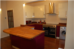 Claret & cream high gloss painted kitchen with oiled Iroko wood worktops. Gallery Thumbnail