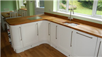 Bespoke Ivory Shaker style kitchen with curved doors and Oak worktops. Gallery Thumbnail