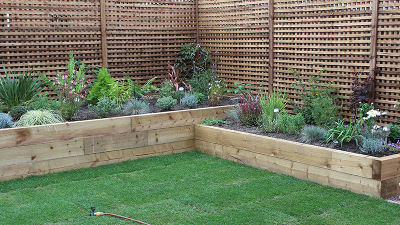 2016 Full Garden landscaping in Felpham heavy duty screening trellis, timber raised borders planted with paving and new lawn Gallery Image