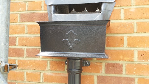 Black, 15" cast aluminium hopper with motif, connected to a 76mm cast collar pipe. Great when trying to replicate the original roofline on olderrs buildings. Brentwood, Essex. Gallery Image