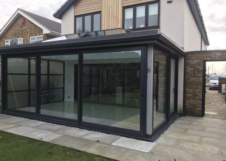 Antracite grey 5"/130mm seamless aluminium gutter to colour match the bi-fold doors on this orangery in Rayliegh, Essex Gallery Image