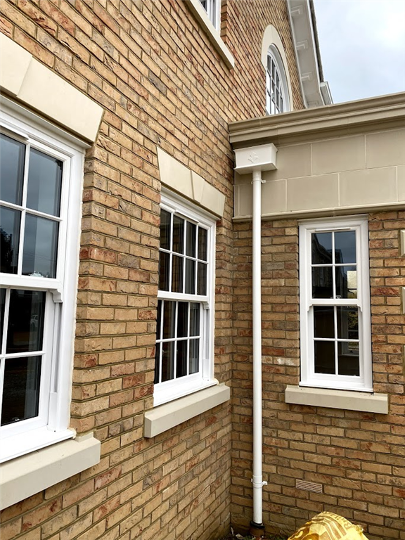 White cast aluminium and pipe to expell from concealed gutters. 
Essendon, Hertfordshire. Gallery Image