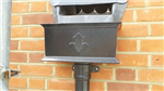 Black, 15" cast aluminium hopper with motif, connected to a 76mm cast collar pipe. Great when trying to replicate the original roofline on olderrs buildings. Brentwood, Essex. Gallery Thumbnail