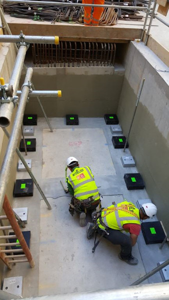Mason Elastomeric Bridge Bearing Natural Rubber Isolation Bearings being placed in a building core pit Gallery Image