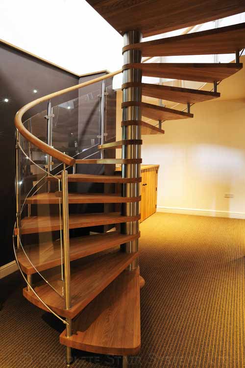 Bespoke Spiral stair with curved glass balustrade and varnished oak treads Gallery Image