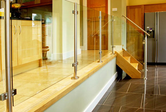 This stylish balustrade features stainless steel newel posts and glass panels Gallery Image
