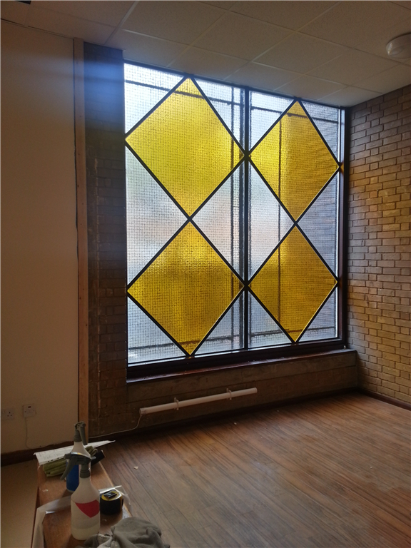Coloured film fitted to replace stained glass pane. Gallery Image