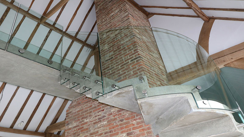 Bolted curved glass balustrade follows step profile and bolted glass balustrade to connecting bridge Gallery Image