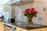 Anhara black leathered finish granite worktops & Arabescato marble splashback, Surrey. Gallery Thumbnail