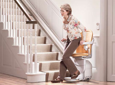 woman getting off a stair lift Gallery Image