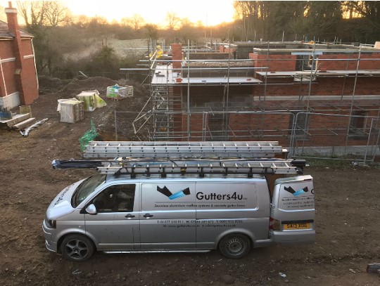 Black seamless aluminium gutter and pipe to new build properties on a development in Stanstead Mountfitchett.  Gallery Image