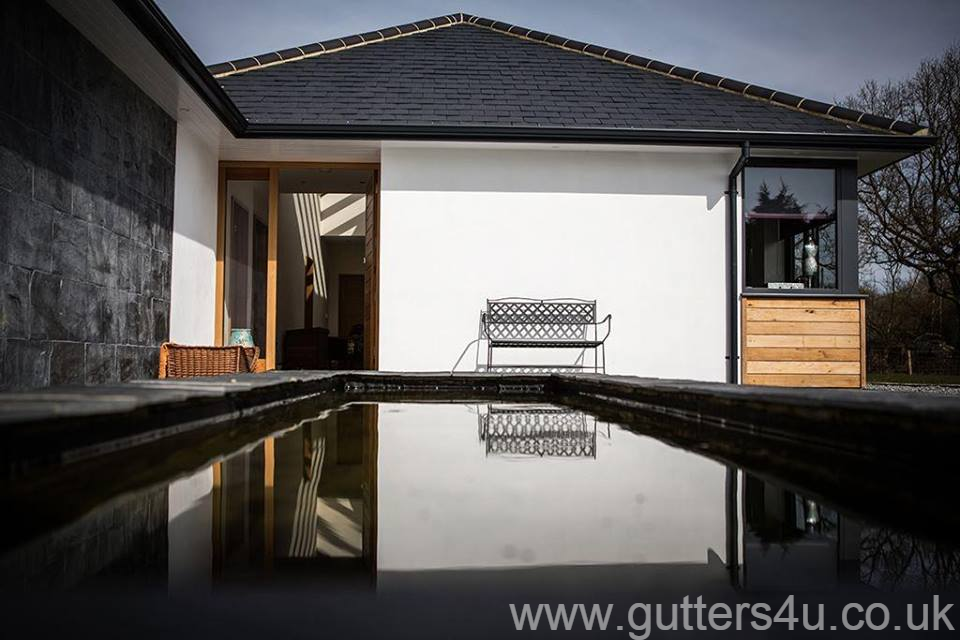 Black seamless aluminium gutter and pipe to a beautiful home in Loughton, Essex. Gallery Image